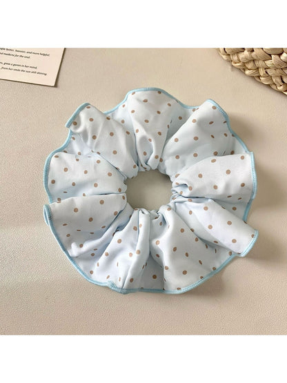 Close-up of Gifty solid color polka dot scrunchie on white background