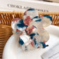 Multicolored flower hair claw clip open to show inner clasp and hinge details