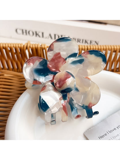 Multicolored flower hair claw clip open to show inner clasp and hinge details