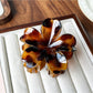 Beau flower shaped claw clip displayed with matching accessories
