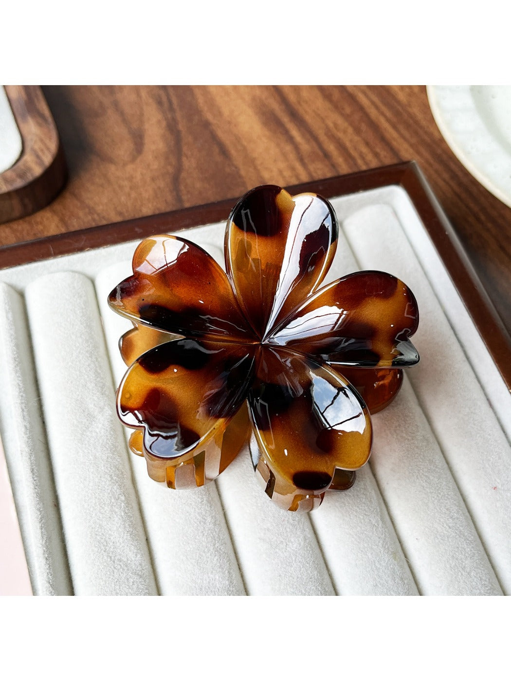 Beau flower shaped claw clip displayed with matching accessories
