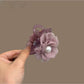 Soft purple romantic hair clip with delicate fabric petals and a metal clasp