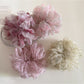 Close-up of Gifty ditsy floral print hair scrunchie in pastel colors on white background