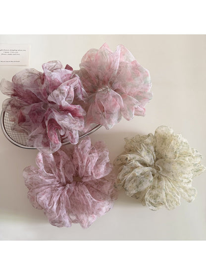 Close-up of Gifty ditsy floral print hair scrunchie in pastel colors on white background