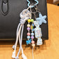 Blue star candy keychain hanging from a set of keys on a wooden surface