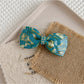 Beau - Marbled Acetate Bow Spring Hair Clip