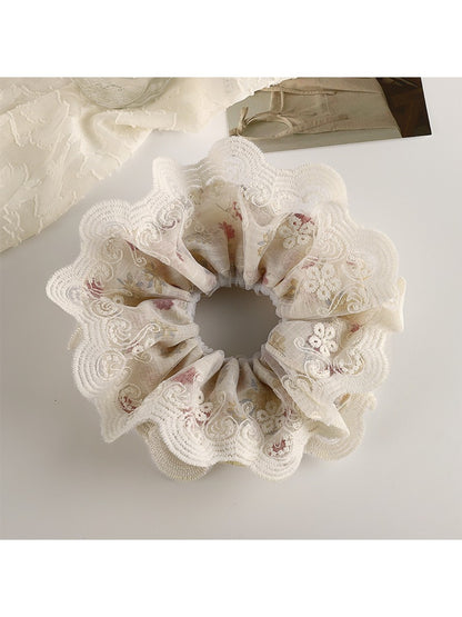 Gifty vintage double layer scrunchie with floral print held in hand against neutral background