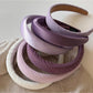 Purple wide edge headband displayed on a white background