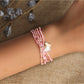 Lovra minimalist multi strand bracelet with small beads and butterfly charm on wrist