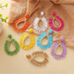 Close-up of Earedge raffia teardrop hollow earring on white background