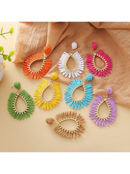 Close-up of Earedge raffia teardrop hollow earring on white background
