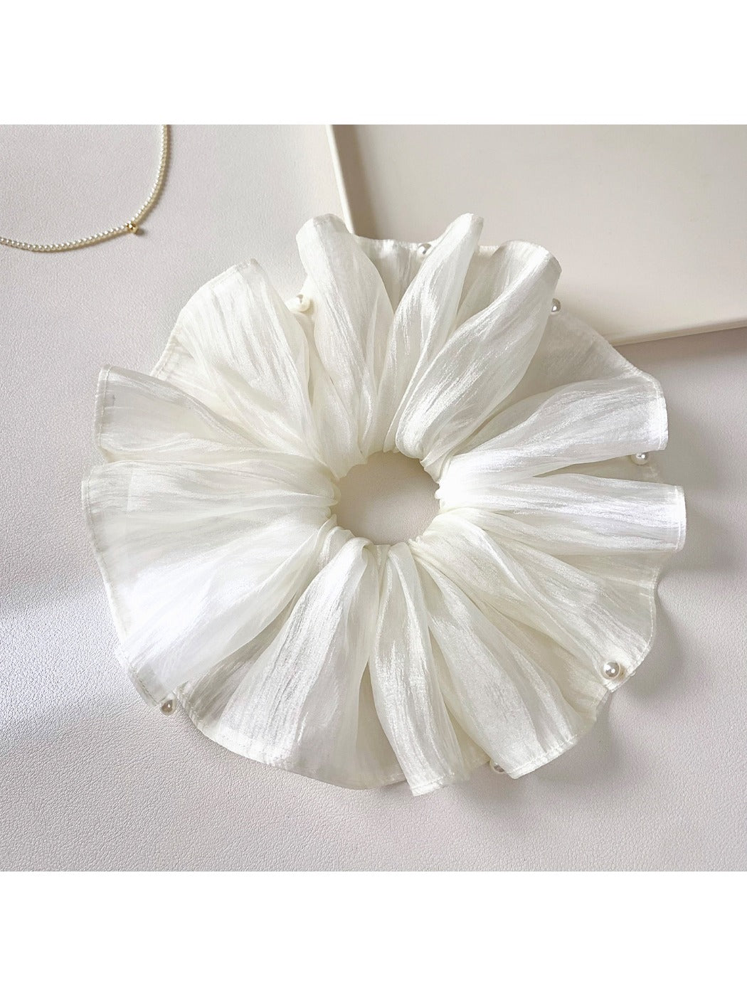 Close-up of white tulle scrunchie showing texture and layers
