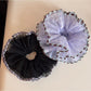 Gifty scrunchie stretched slightly to display elasticity and tulle fabric details
