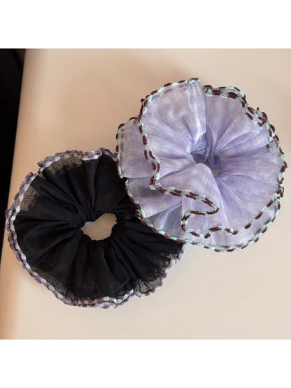 Gifty scrunchie stretched slightly to display elasticity and tulle fabric details