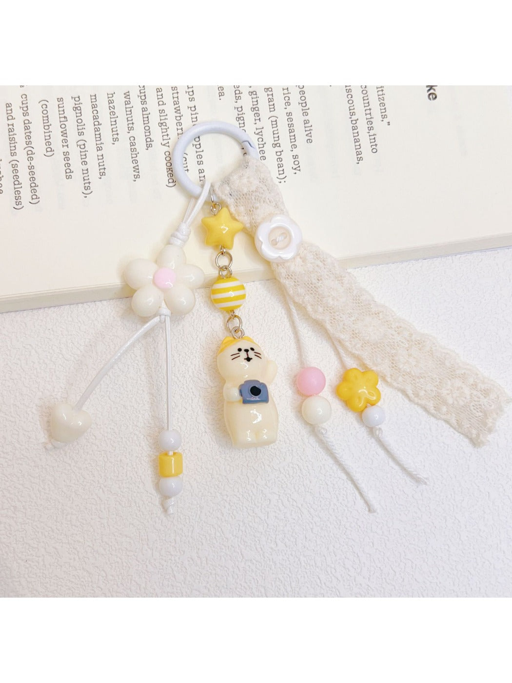 Side view of the cat keychain attached to a silver keyring