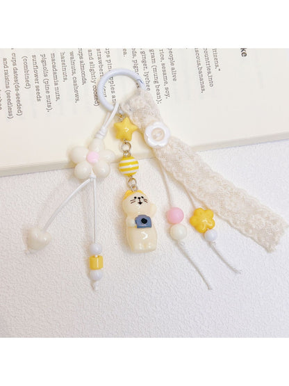 Side view of the cat keychain attached to a silver keyring