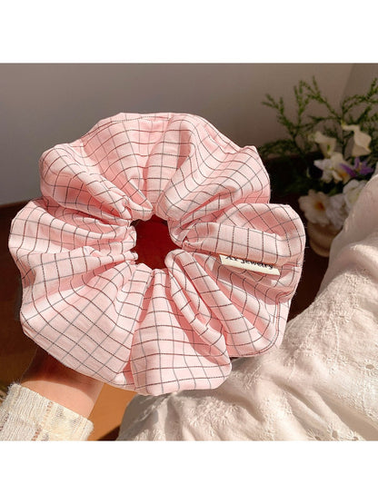 Multiple Gifty Lazy Style textured scrunchies stacked together