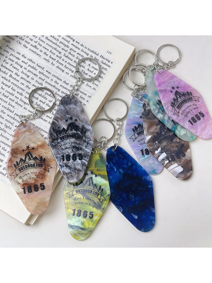 Colorful diamond-shaped pendant keychain with vibrant geometric pattern on white background