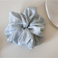 Multiple Gifty soft polka dot scrunchies stacked together in various pastel colors