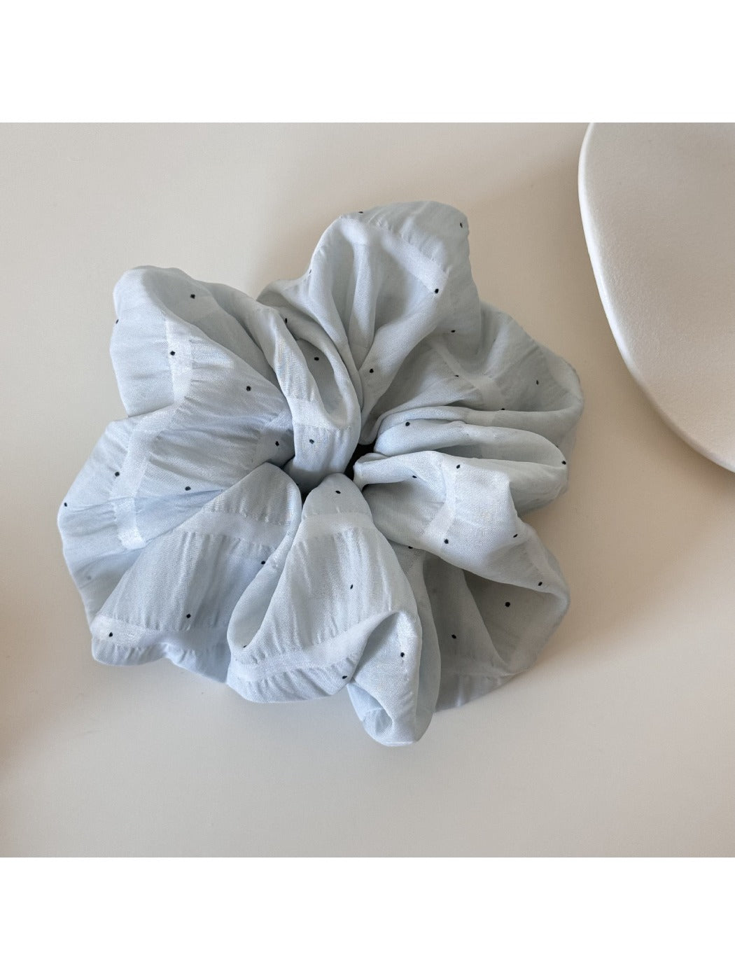 Multiple Gifty soft polka dot scrunchies stacked together in various pastel colors