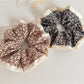 Gifty scrunchie with delicate floral lace trim displayed on a white background