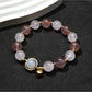 Close-up of Lovra heart pendant with small round beads on bracelet