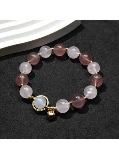 Close-up of Lovra heart pendant with small round beads on bracelet