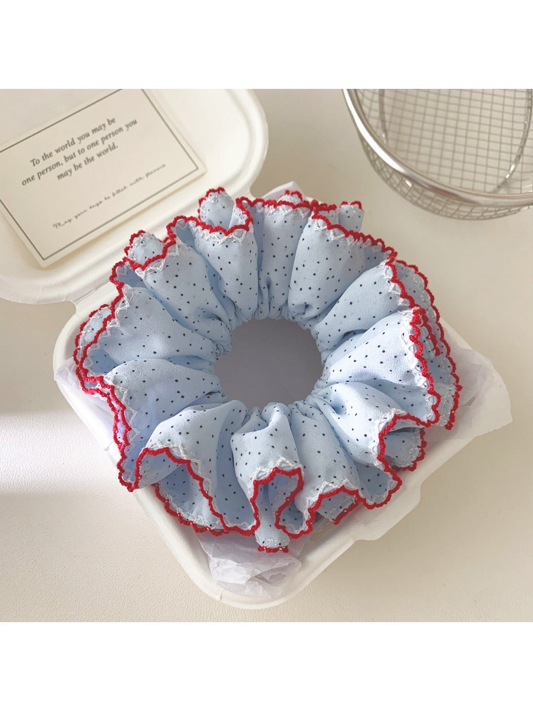 Close-up of Gifty polka dot ruffle scrunchie showing fabric texture and pattern