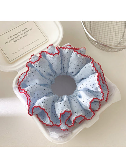 Close-up of Gifty polka dot ruffle scrunchie showing fabric texture and pattern