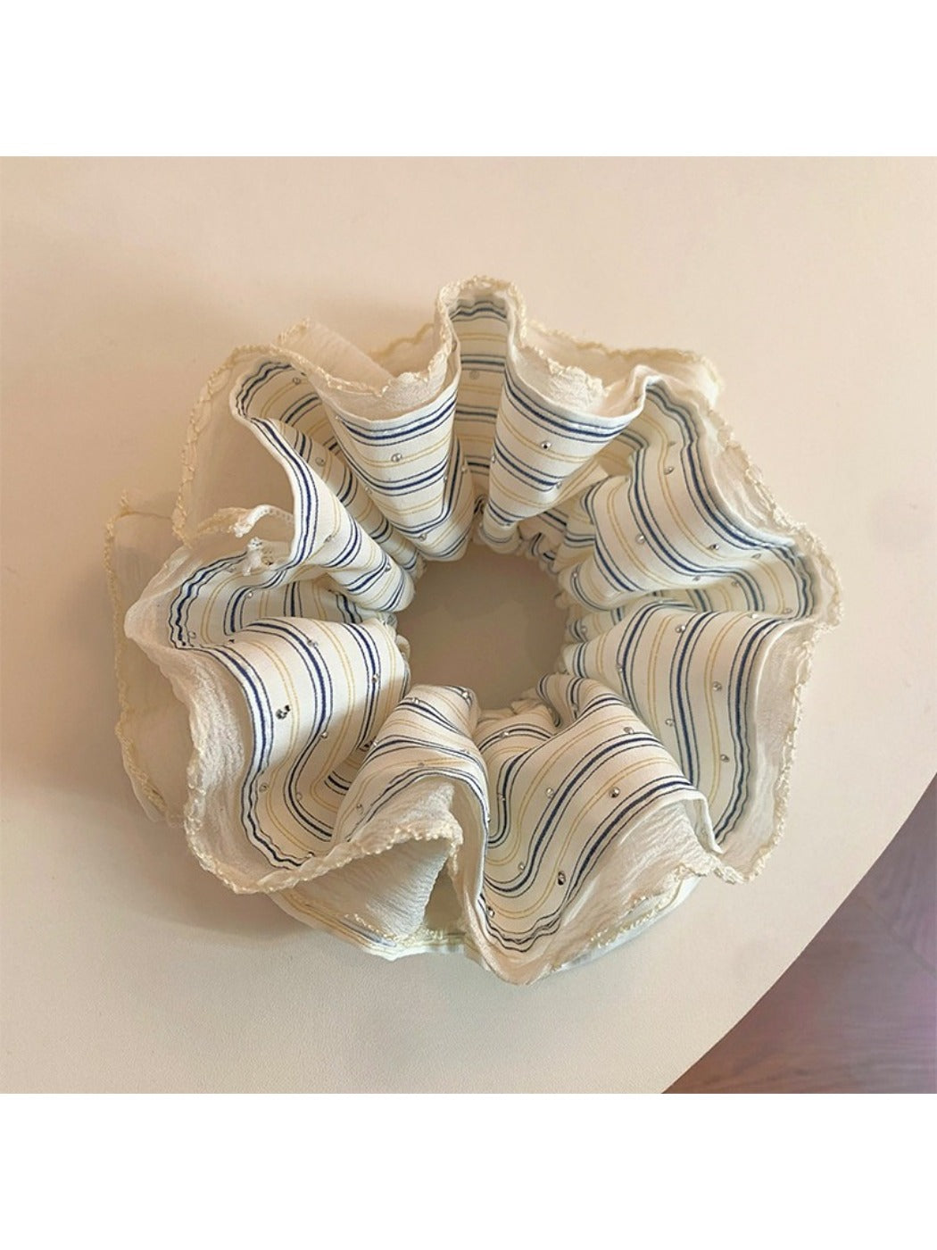 Close-up of Gifty modern minimalist striped scrunchie in neutral tones on white background