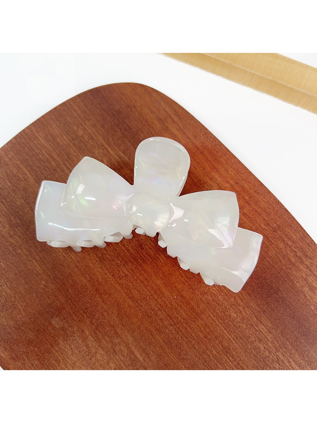 Beau hair claw clip displayed on a wooden surface