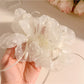 White double layer scrunchie displayed next to matching minimalist accessories