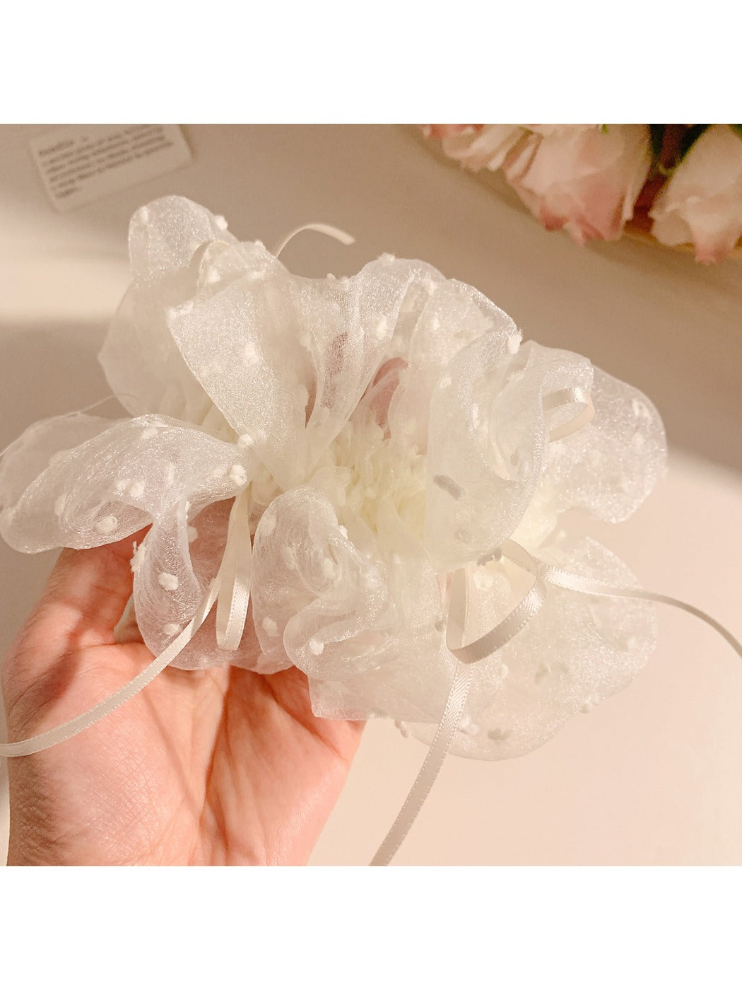 White double layer scrunchie displayed next to matching minimalist accessories