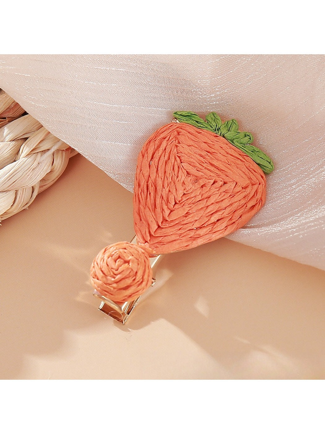 Beau raffia strawberry flower hair clip displayed with matching accessories