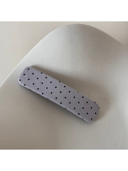 Beau hair clip held near face to show scale and design details