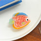 Top view of Beau tropical fish hair clip showing smooth glossy finish and fish design