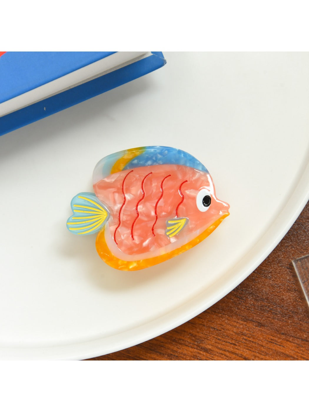 Top view of Beau tropical fish hair clip showing smooth glossy finish and fish design