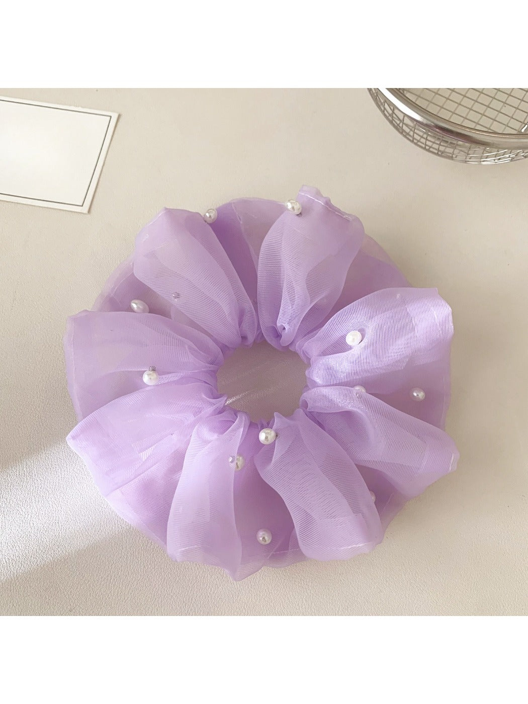 Close-up of Gifty chic elegant tulle scrunchie in soft beige color