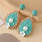 Detailed shot of Earedge earrings highlighting smooth teardrop design