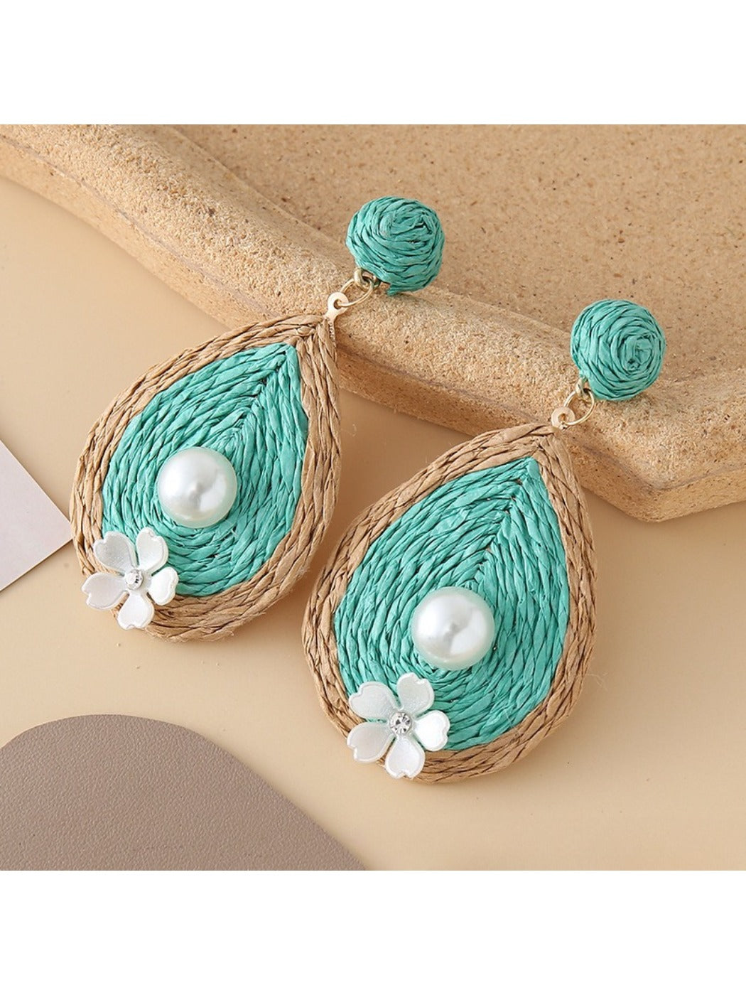 Detailed shot of Earedge earrings highlighting smooth teardrop design