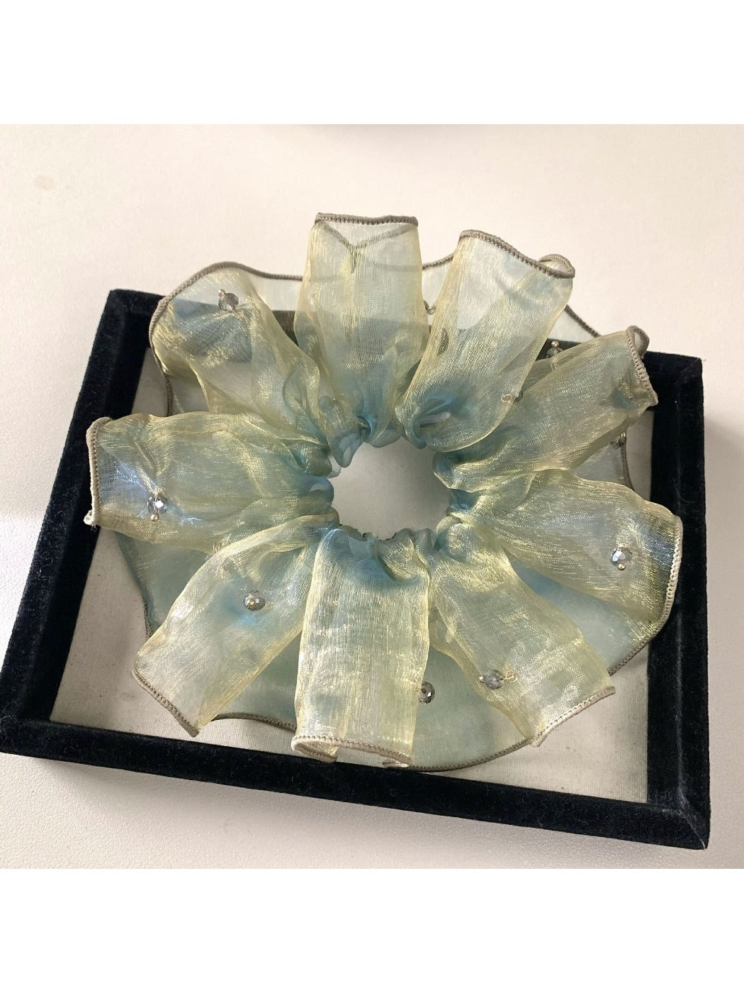 Flat lay of multiple vintage minimalist ombre hair scrunchies in different pastel shades