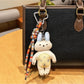 Close-up of Keypus kitty charm showing detailed facial features and soft colors