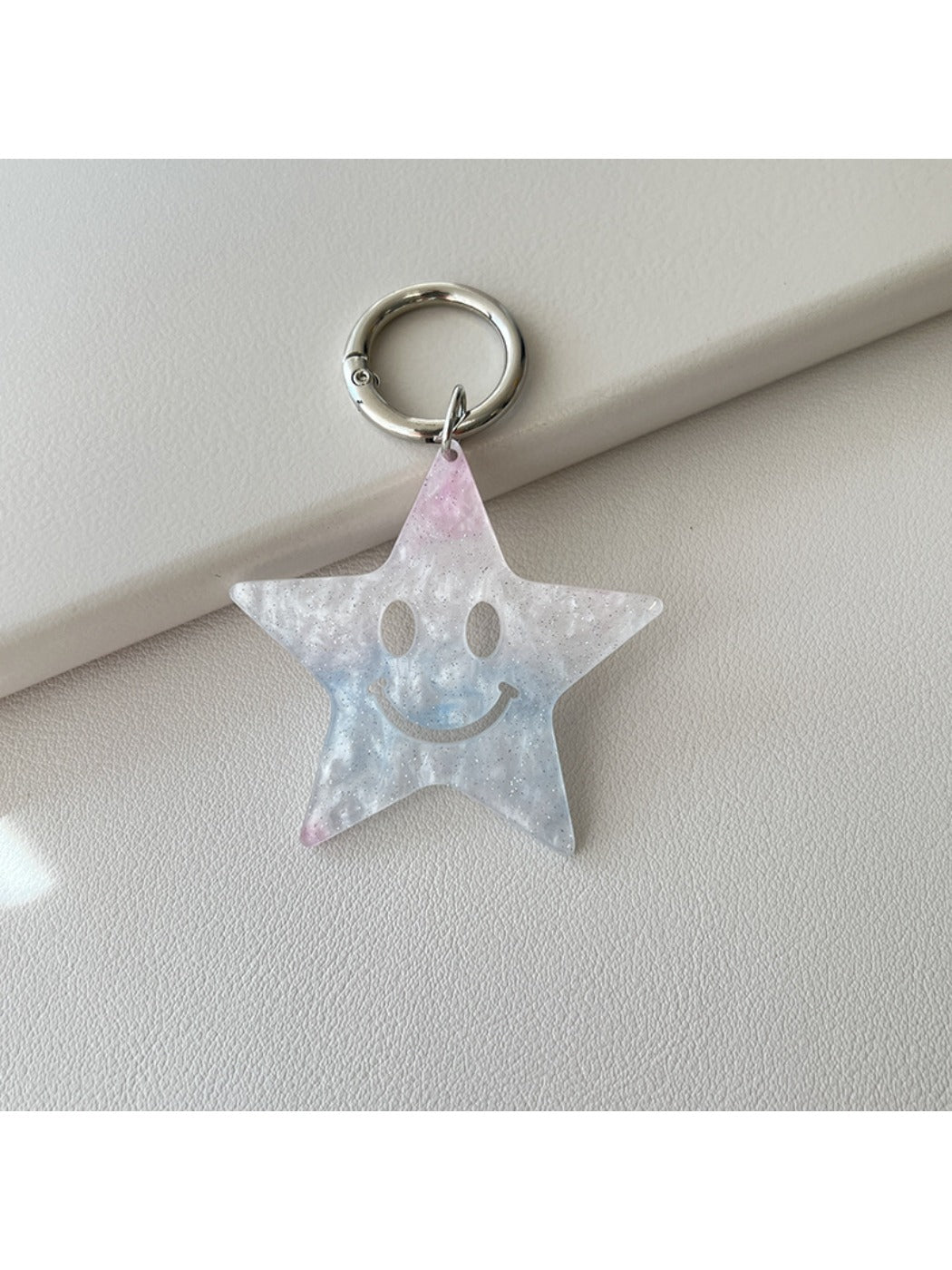 Star pendant keychain shown with a close-up of the keyring attachment