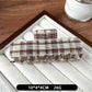 Beau plaid updo claw clip resting on a wooden surface