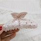 Beau rainbow claw clip displayed with a blurred background