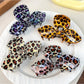 Close-up of Beau leopard print bow claw clip showing textured pattern
