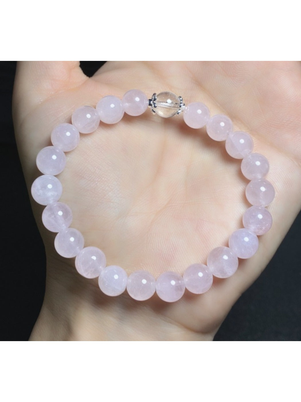 Detailed shot of pink crystal beads and silver spacer beads on Lovra bracelet