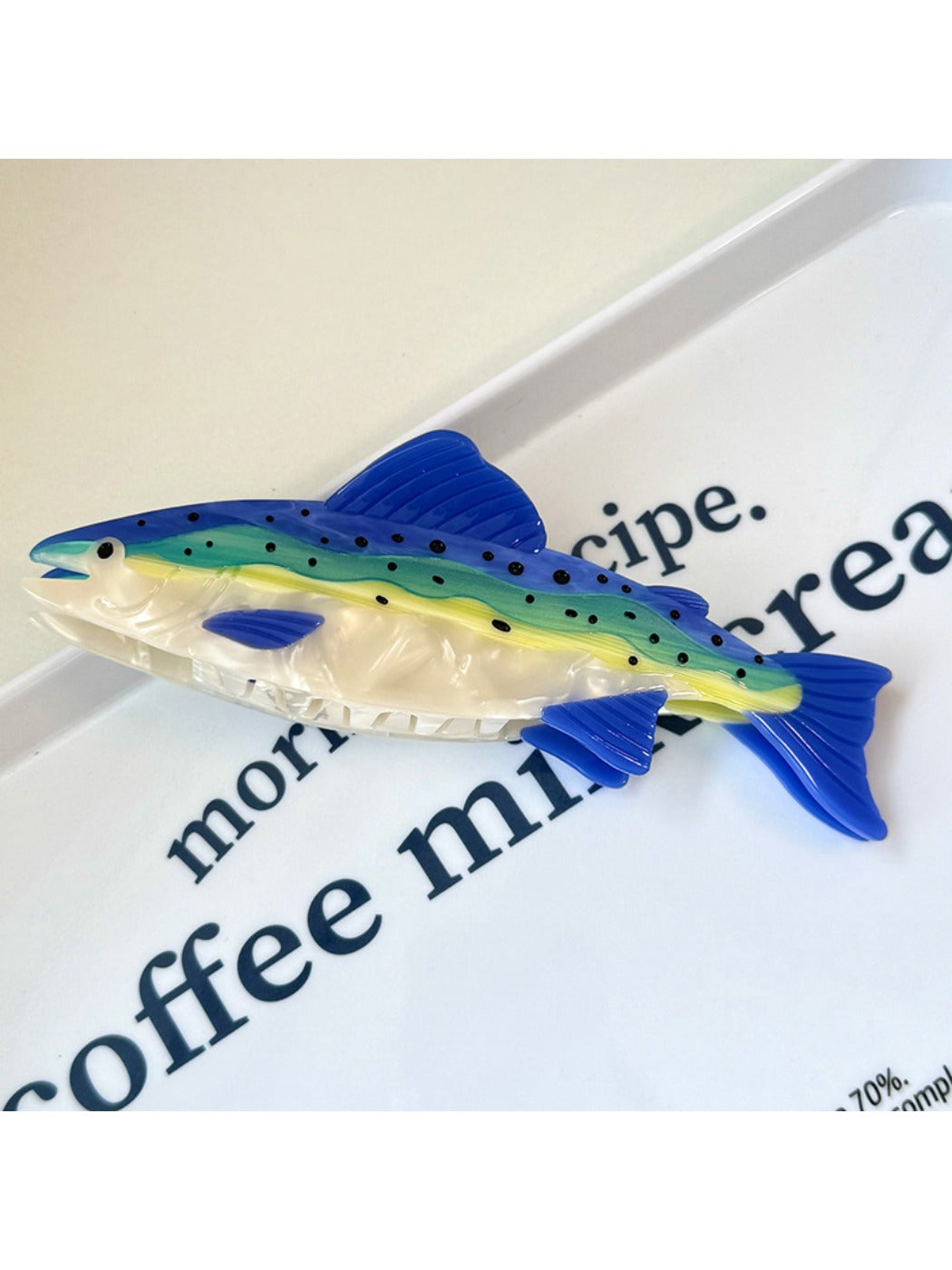 Beau colorful fish hair claw clip held in hand showing size and grip