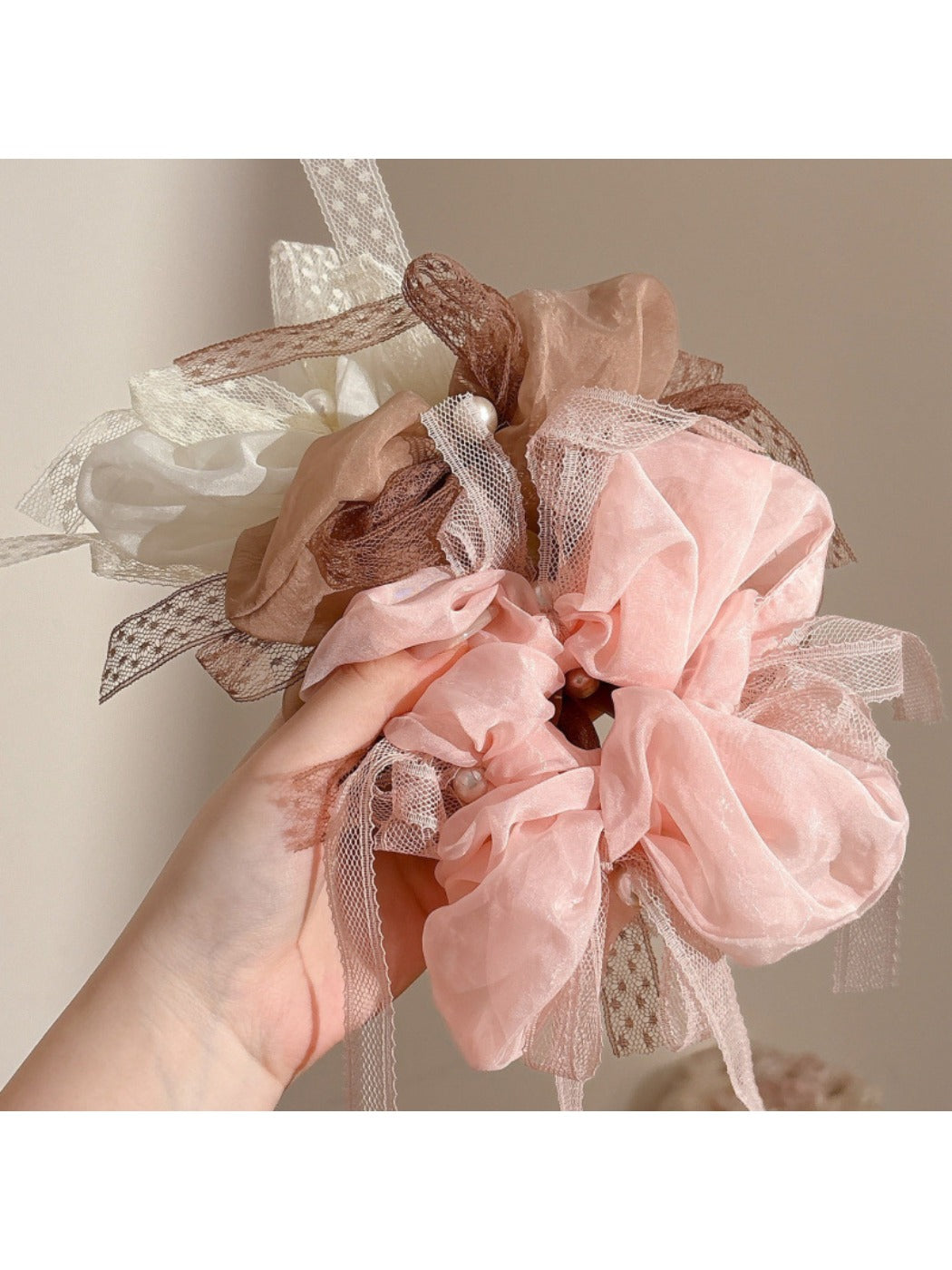 Gifty scrunchie styled on a wrist showing bow detail and gathered fabric