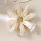 Flat lay of Gifty striped ruched scrunchie on a neutral background